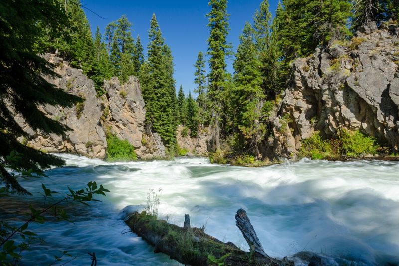 Whitewater of Benham Falls pouring past rocky cliffs on the Deschutes River