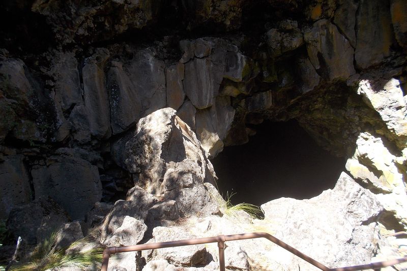Rocky collapse pit and handrail leading down into Lava River Cave