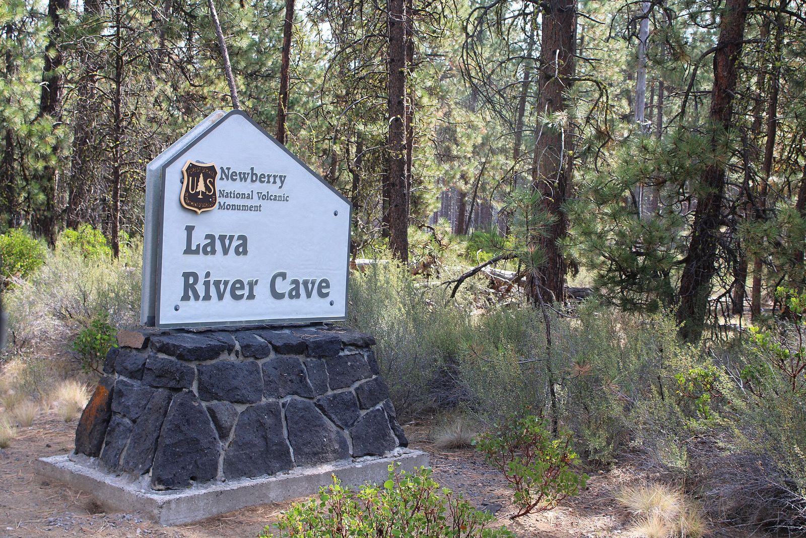 Newberry National Volcanic Monument sign for Lava River Cave among pines
