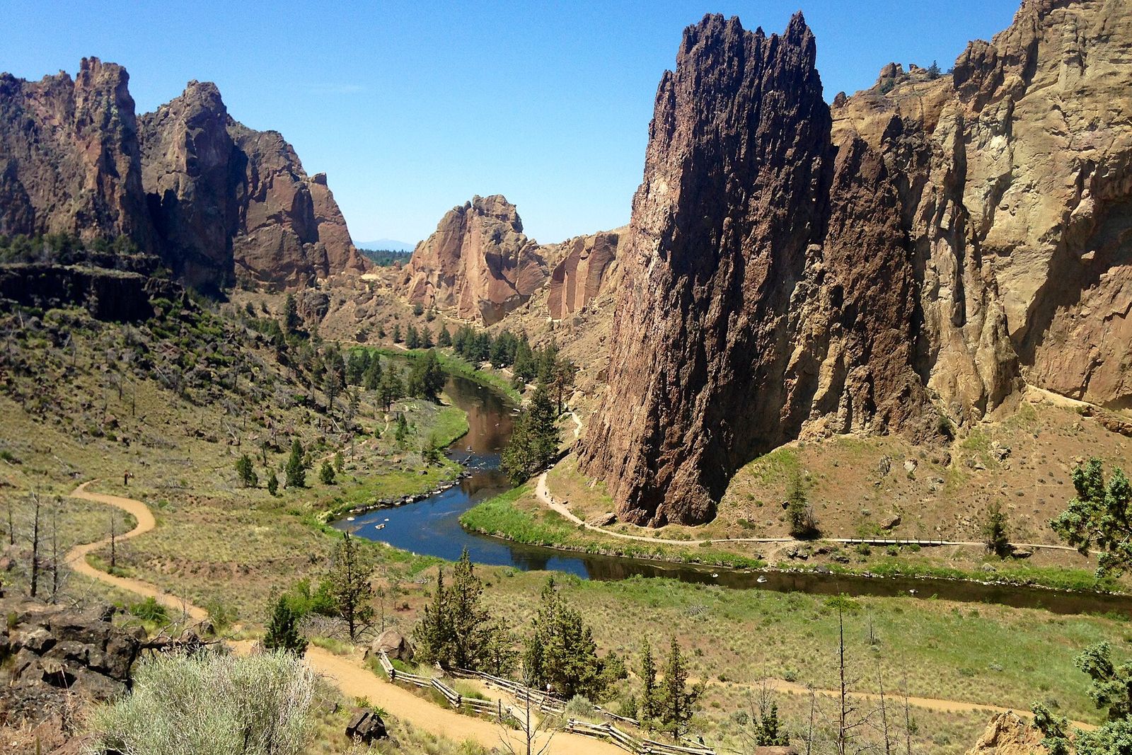 Smith Rock's orange cliffs above the Crooked River bend in afternoon light
