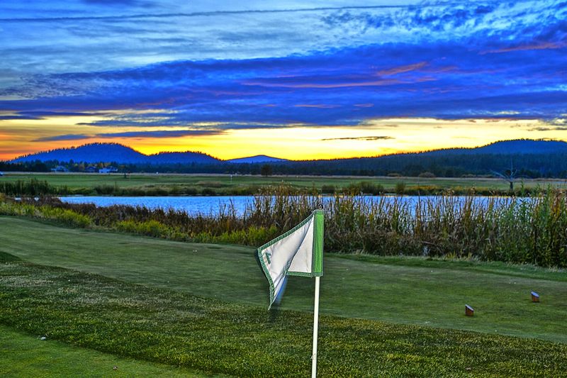 Sunset over the Sunriver Meadows golf course with mountains on the horizon
