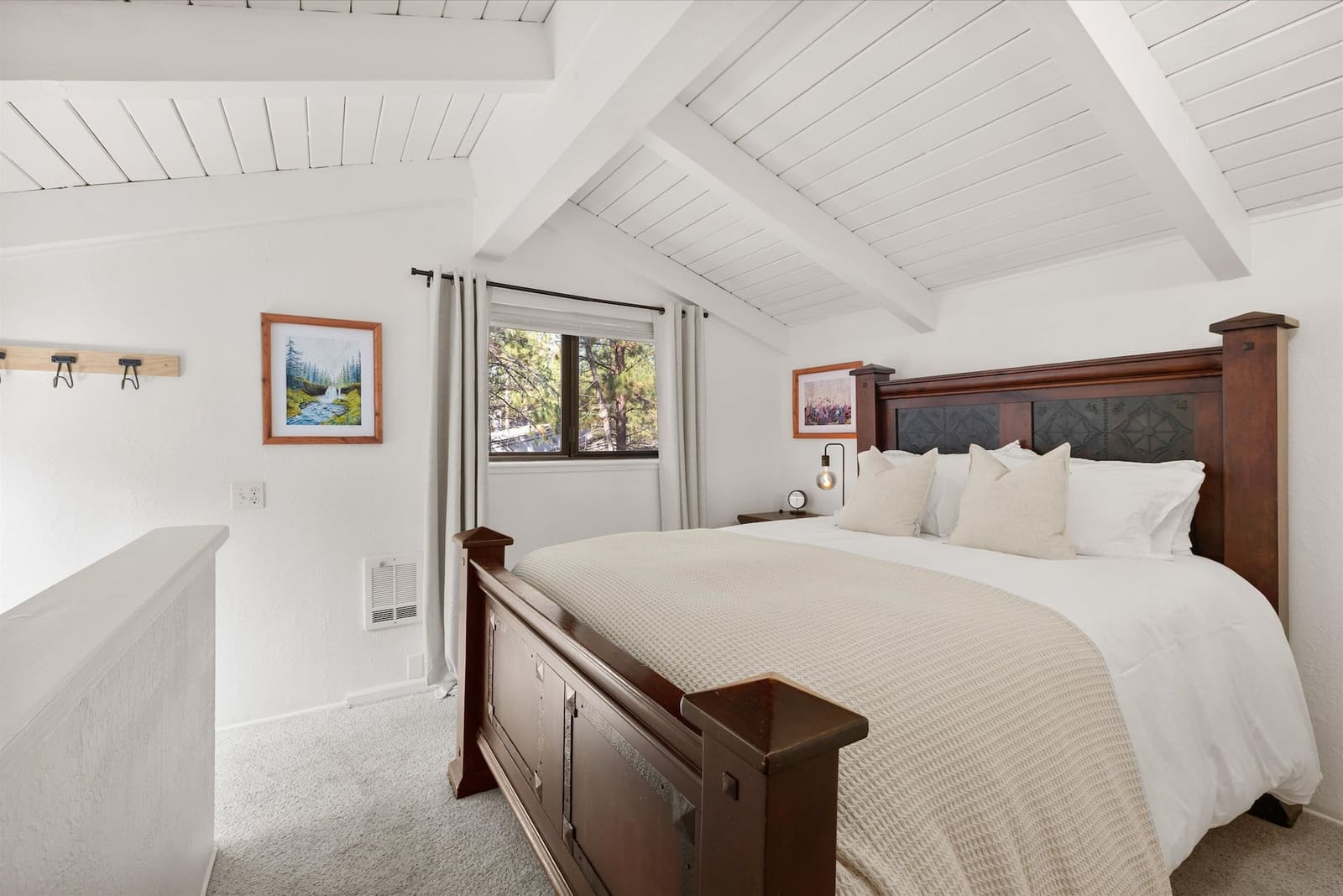 Bedroom two seen from the landing, with a window looking into the pines