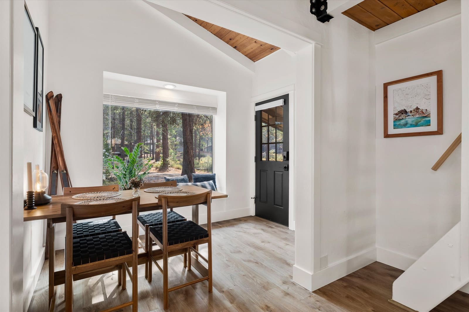 Dining area beside the front door, with a window framing the surrounding ponderosas